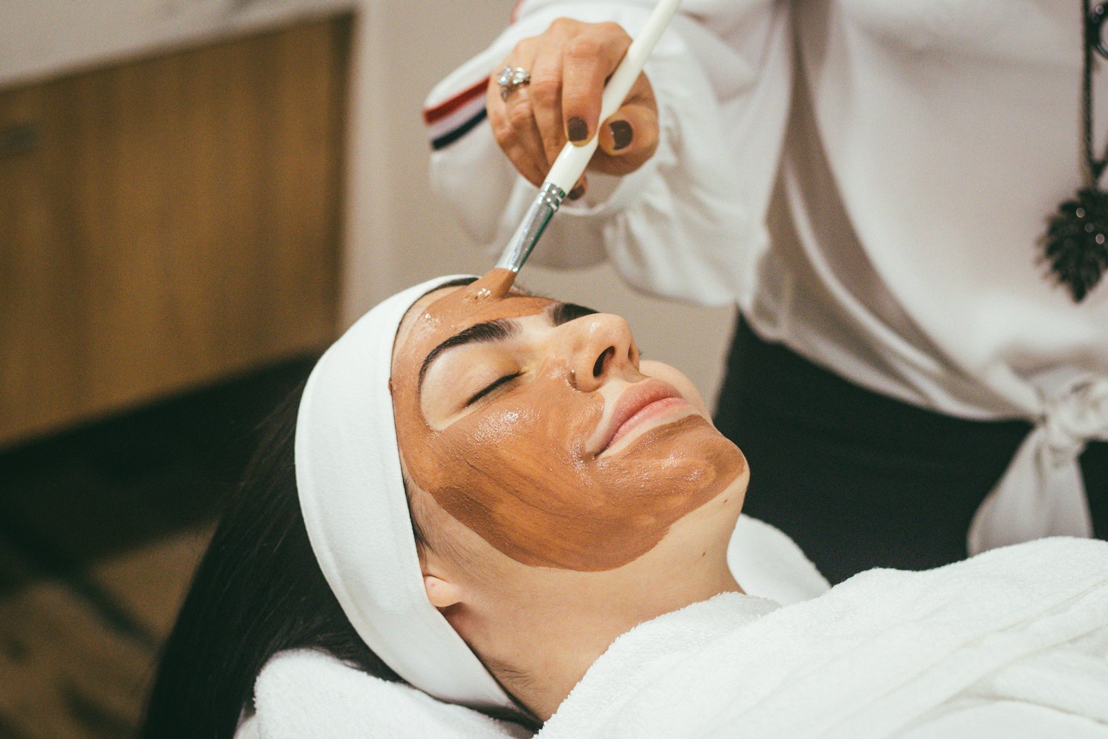 Client relaxing during a med-spa facial treatment